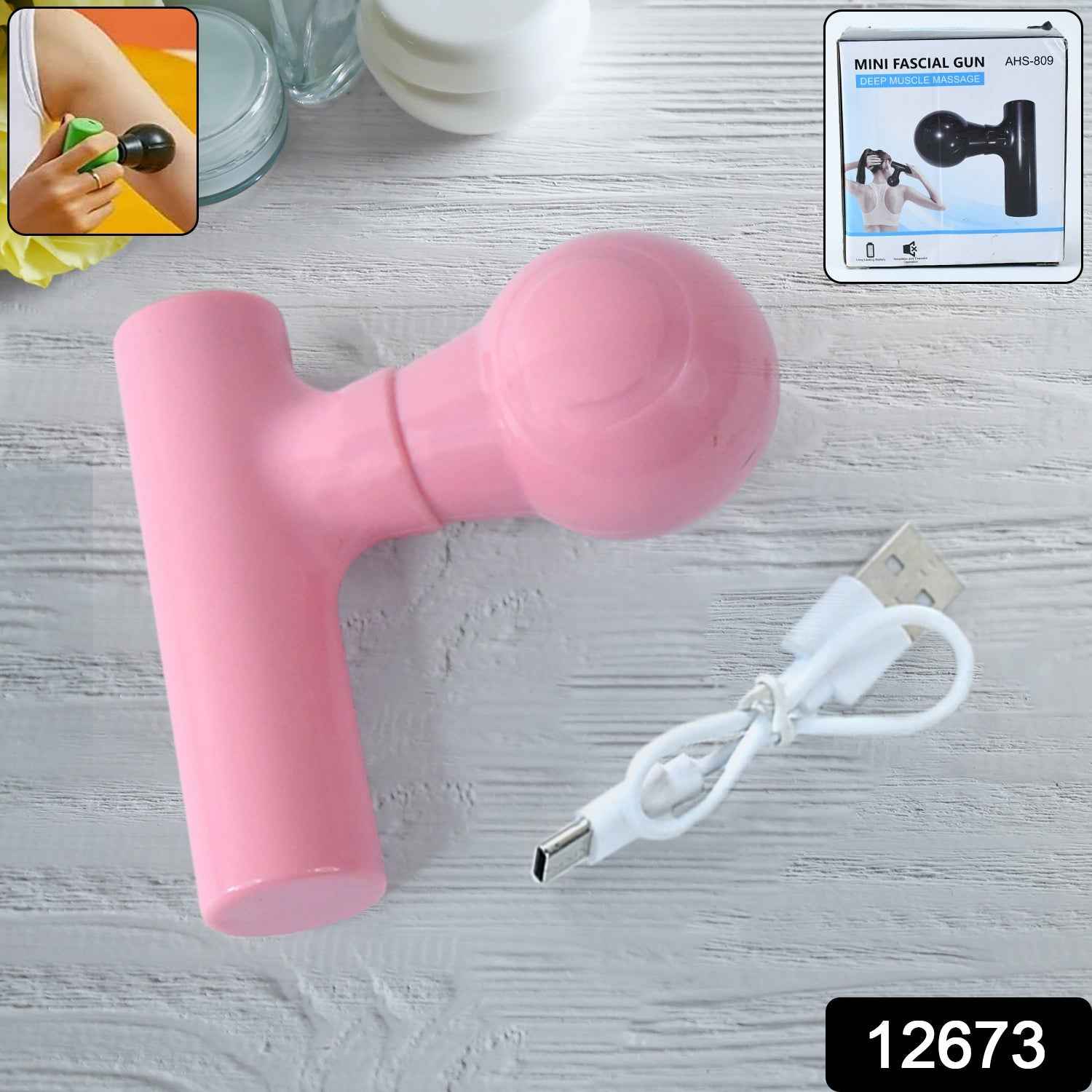 Black mini body massager shown with its charging cable.