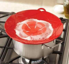 Silicone Spill Stopper Lid preventing boil-over on a cooking pot.