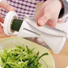 Easy-to-use kitchen slicer transforming carrots into spirals for a fresh salad.