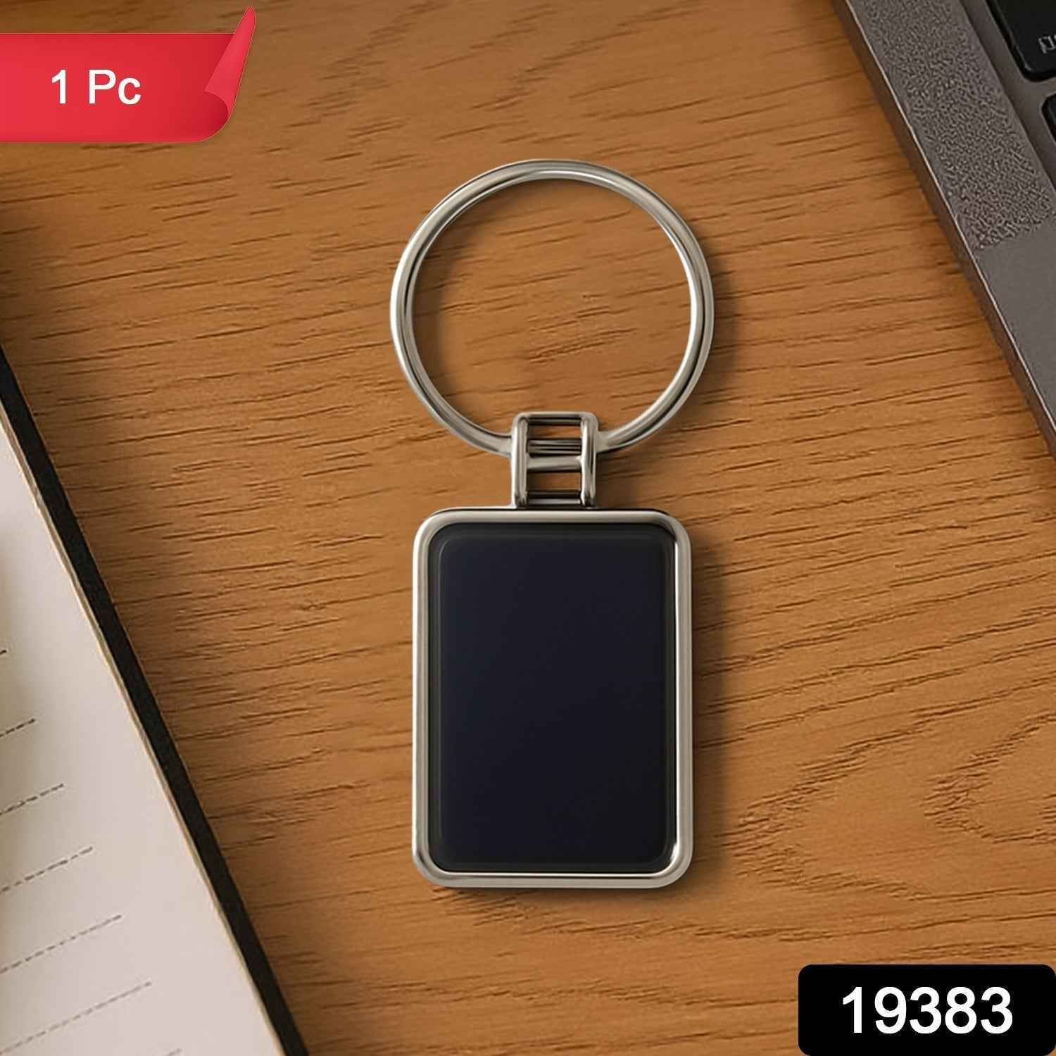 Black and silver rectangular metal keychain featuring metro stripe design