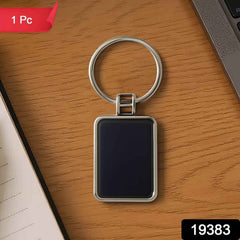Black and silver rectangular metal keychain featuring metro stripe design